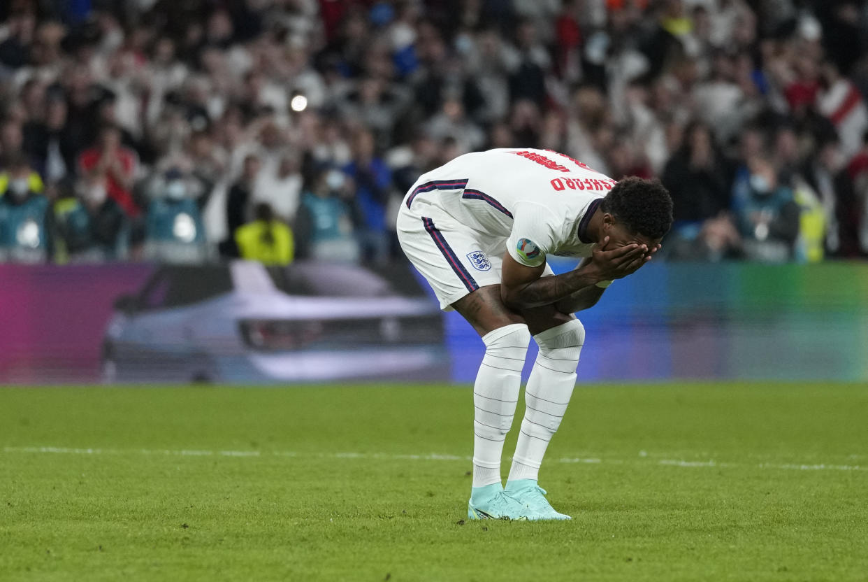 TOPSHOT - England's forward Marcus Rashford reacts after failing to score in the penalty shootout during the UEFA EURO 2020 final football match between Italy and England at the Wembley Stadium in London on July 11, 2021. (Photo by Frank Augstein / POOL / AFP) (Photo by FRANK AUGSTEIN/POOL/AFP via Getty Images)