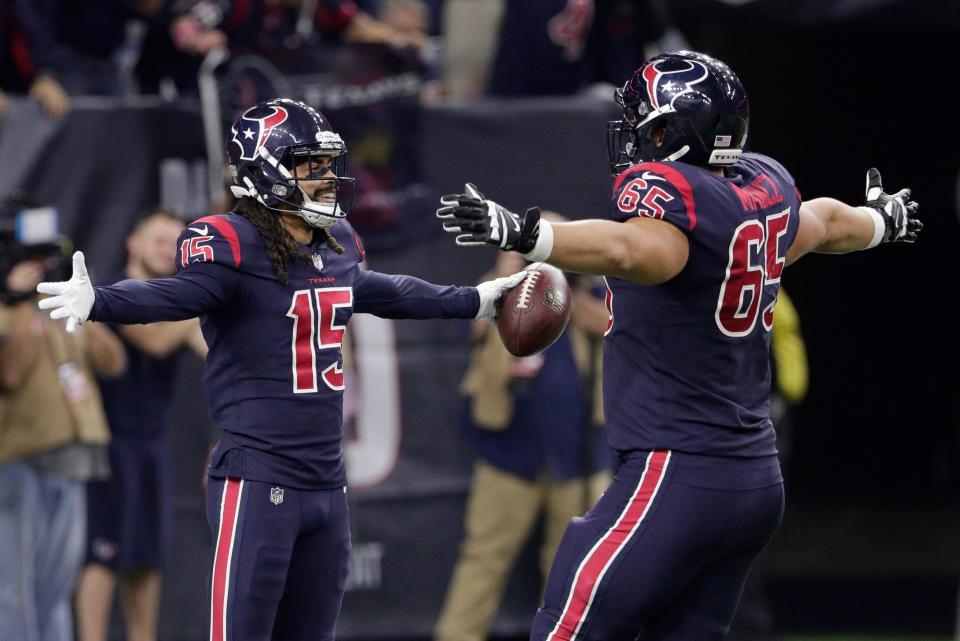 Houston Texans wide receiver Will Fuller (15) celebrates his touchdown catch with teammate Greg Mancz (65) during the second half of an NFL football game, Thursday, Oct. 25, 2018, in Houston. (AP Photo/Michael Wyke)