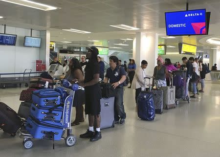 Delta passengers wait to check in following a Delta Airlines system-wide computer breakdown, at Newark International Airport in Newark, New Jersey, U.S. August 8, 2016. REUTERS/Joseph Ax