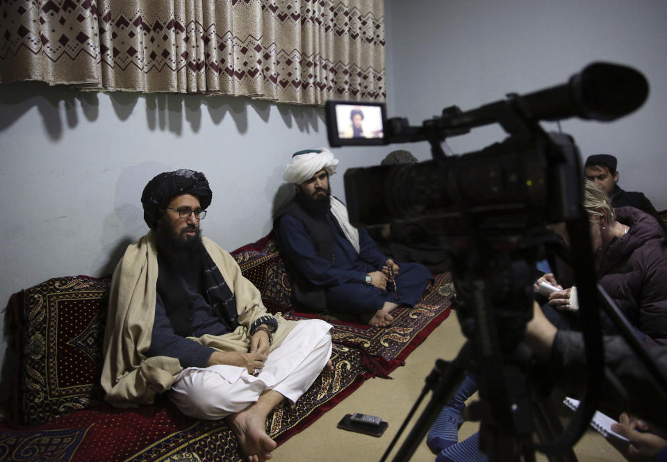 In this Saturday, Dec. 14, 2019, photo, Maulvi Niaz Mohammad, 45, left, speaks during an interview with The Associated Press inside the Pul-e-Charkhi jail in Kabul, Afghanistan. Mohammad is serving a 15-year jail term. During the Taliban rule he served with Qari Ahmadullah, a Taliban intelligence commander that controlled much of northern Afghanistan. (AP Photo/Rahmat Gul)