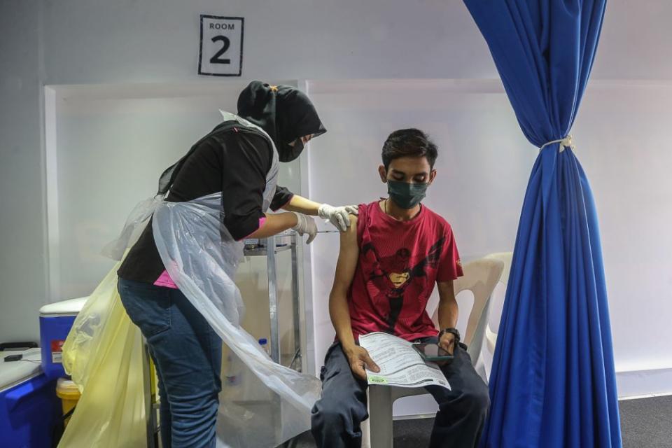 People receive their Covid-19 vaccination through the MYMedic@Wilayah Vaccine Mobile Truck programme at PPR Seri Alam in Kuala Lumpur June 23, 2021. — Picture by Yusof Mat Isa