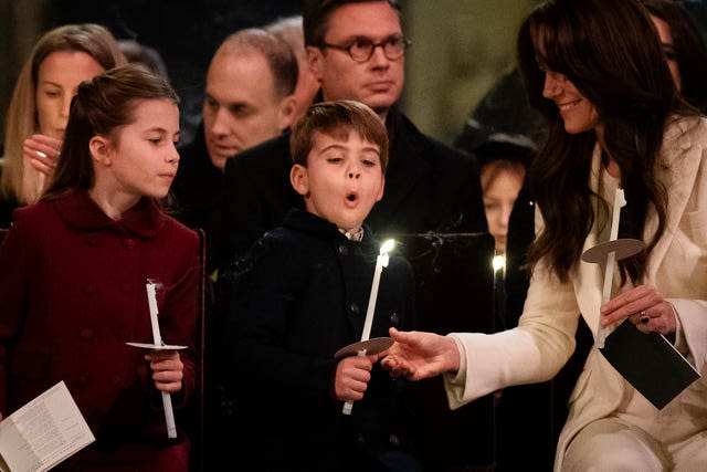 (left to right) Princess Charlotte, Prince Louis blowing out his candle and the Princess of Wales during the Royal Carols – Together At Christmas service at Westminster Abbey in London.