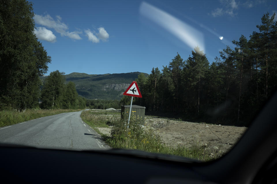 A sign warning of low-flying aircraft is posted on the road to the Voss flyklubb airfield in Norway, on Sept. 27, 2022. (AP Photo/Bram Janssen)