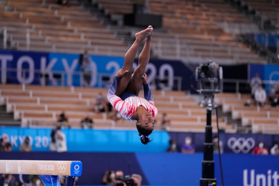 Simone Biles dismounts the balance beam.