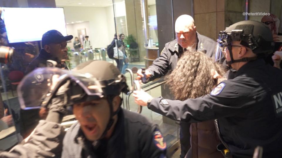 McCarthy could be seen having trouble getting the glass doors open as the protesters circled behind him, effectively trapping the cops and yelling profanities. Peter Hambrecht