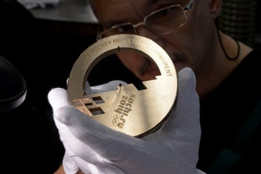 An employee works on a bronze medal for the 2014 Winter Olympic Games in Sochi, at the Adamas jewellery factory in Moscow on July 25, 2013.Tajikistan may be the poorest of the five former Soviet Republics known as the "Stans" but that does not stop the landlocked Central Asian country from dreaming big, even on the sporting front