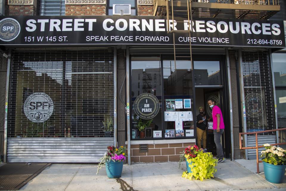 FILE - In this Saturday, July 18, 2020, file photo, Iesha Sekou, founder and CEO of Street Corner Resources leaves the program headquarters with workers to "Occupy the Corners", visiting and observing potential areas of conflict and gun violence, in the Harlem neighborhood of New York. A rise in gun violence in cities across the U.S. is testing the limits of anti-violence groups that have been calling for more government funding for decades. President Joe Biden acknowledged earlier this year that community anti-violence programs have been woefully underfunded and has proposed $5 billion in new aid for them. (AP Photo/Frank Franklin II, File)