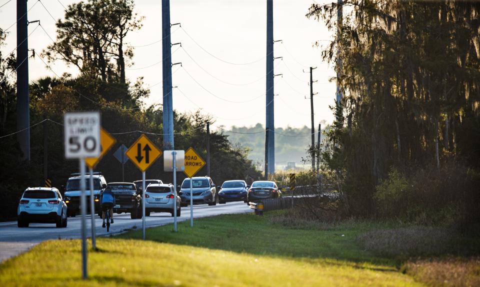 Traffic moves down Oil Well Road in Collier County. The area has several proposed developments that are slated to be built on the surrounding land. 