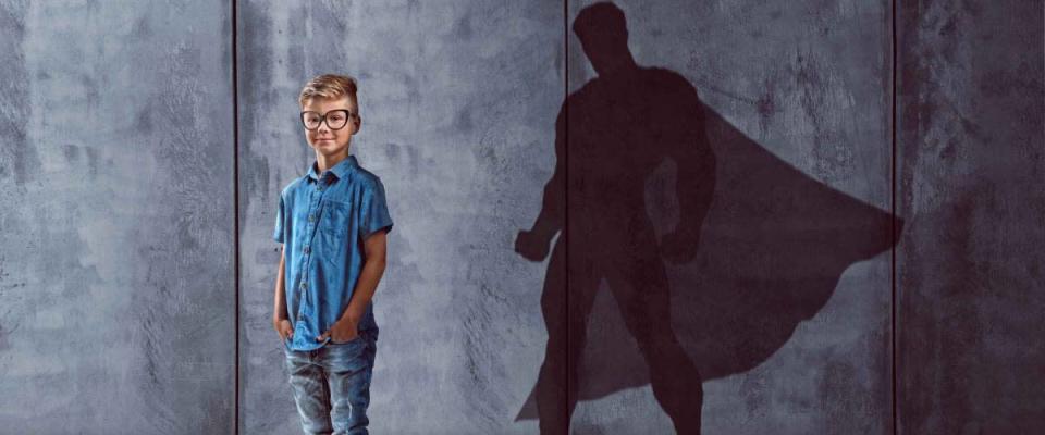 Child with superhero shadow