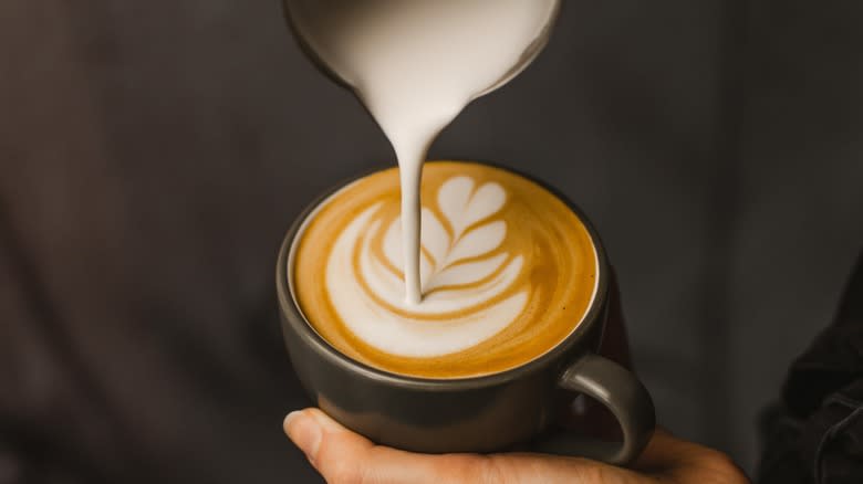 milk pouring in cappuccino