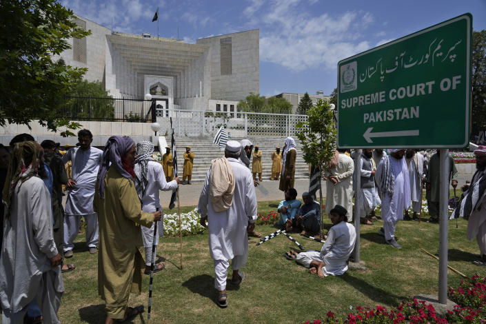 Supporters of Pakistan Democratic Movement, an alliance of the ruling political parties, gather to attend a rally outside the Supreme Court in Islamabad, Pakistan, Monday, May 15, 2023. Convoys of buses and vehicles filled with Pakistani pro-government supporters are flooding the main road leading to the country's capital on Monday to protest the release of former Prime Minister Imran Khan. (AP Photo/Anjum Naveed)