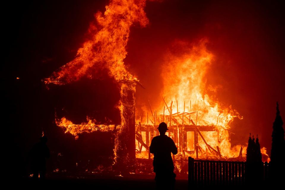 A home burns as the Camp Fire rages through Paradise, Calif., on Nov. 8, 2018. Pacific Gas & Electric officials pleaded guilty June 16 to 84 counts of involuntary manslaughter in the wildfire, which nearly wiped out the Northern California town.