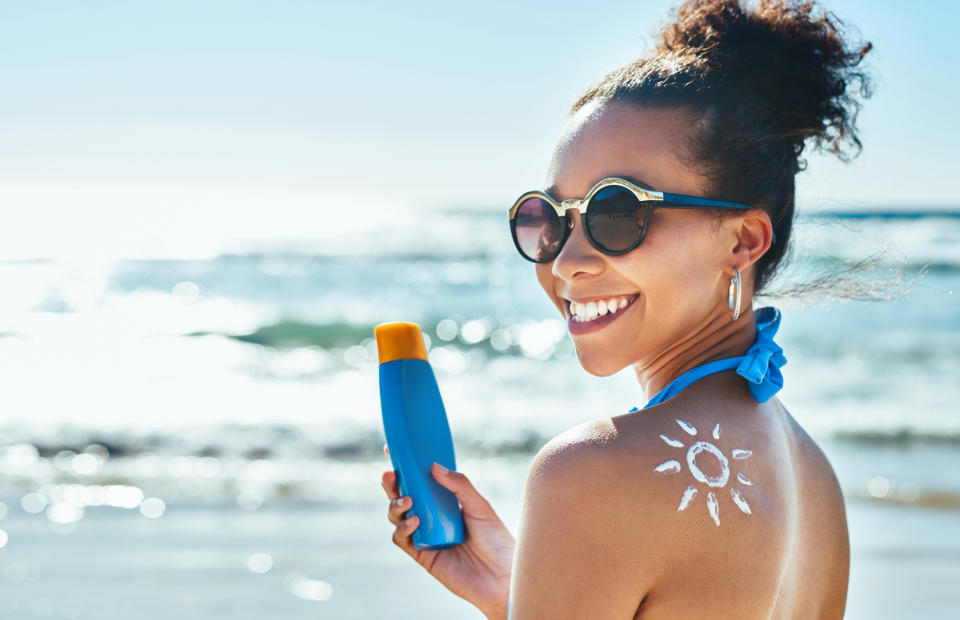 person holding up sunscreen