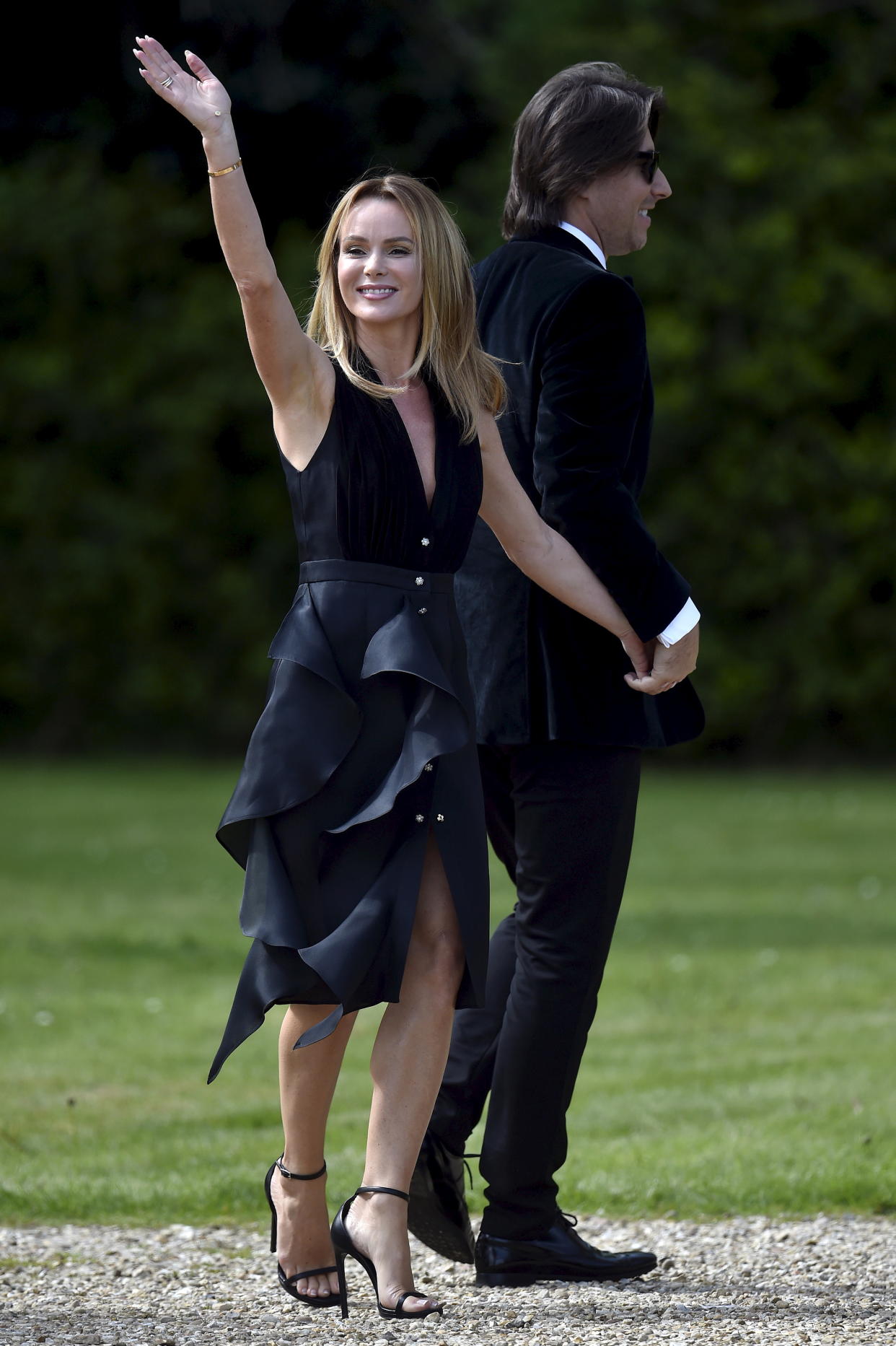 Guests, British television presenter Amanda Holden (L) and her husband Chris Hughes arrive for the wedding of British singer and former member of the band Spice Girls, Geri Halliwell and Christian Horner, Red Bull Formula One team principal, at St. Mary's Church at Woburn in southern England May 15, 2015. REUTERS/Toby Melville