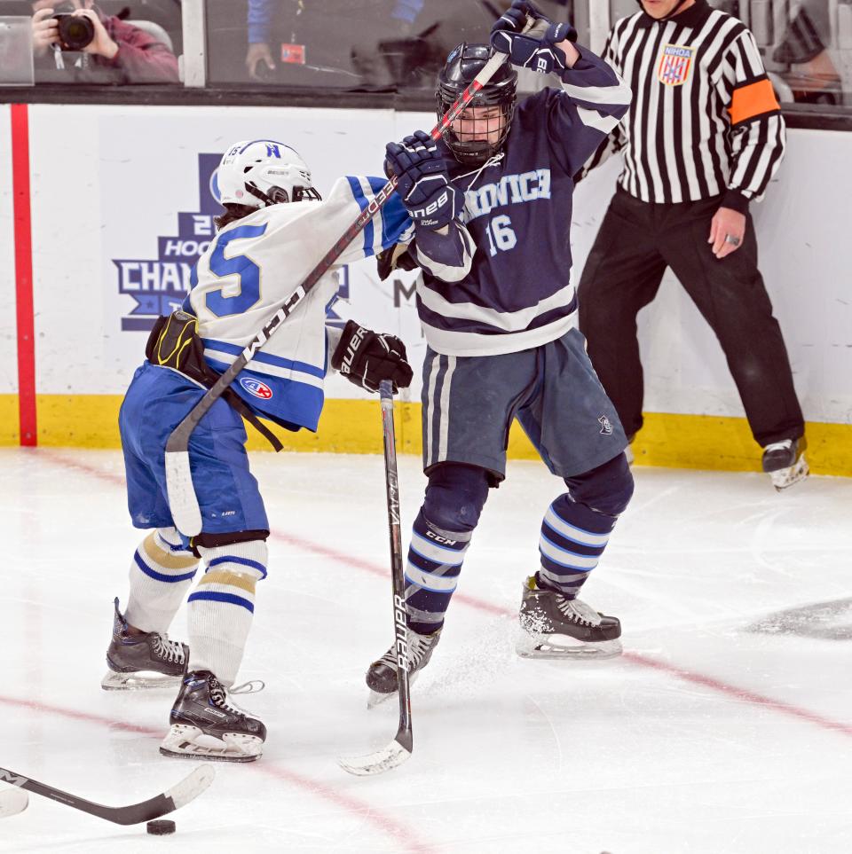 BOSTON 03/19/23  Brayden Ramsey of Sandwich tangles with Aedan Coyle of Norwell in the MIAA Division 4 final hockey