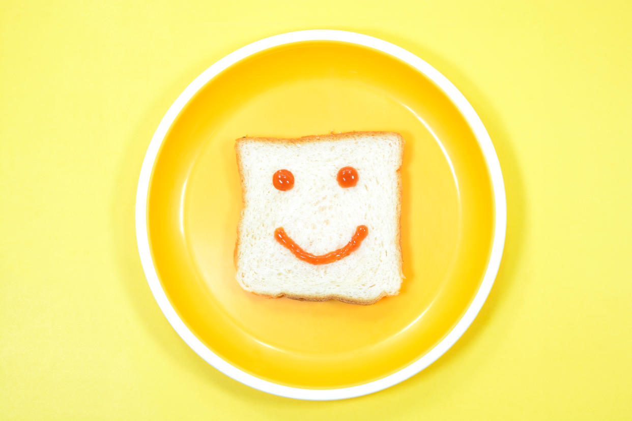 Smiley face decorated on a bread.