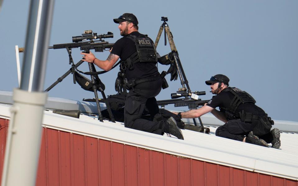 Police snipers return fire after shots were fired at Donald Trump at the campaign rally in Butler Farm Show grounds