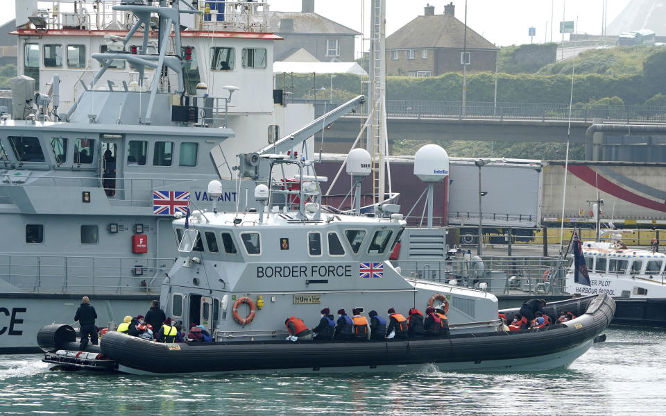 A group of people thought to be migrants are brought into port aboard a Border Force vessel, at Dover, England, Monday July 26, 2021. The group of people were picked up by the border force vessel following a small boat incident in the Channel. (Gareth Fuller/PA via AP)