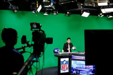 Chinese commentator Wang Zixing comments on a NFL American football game during a lifestream broadcast in a studio of the media and gaming firm Tencent Holdings in Beijing, China, October 16, 2017. REUTERS/Thomas Peter