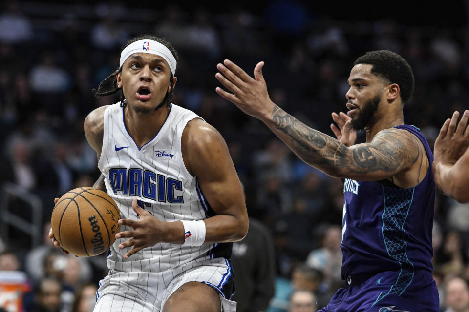 Orlando Magic forward Paolo Banchero drives to the basket against Charlotte Hornets forward Miles Bridges during the second half of an NBA basketball game Tuesday, March 5, 2024, in Charlotte, N.C. (AP Photo/Matt Kelley)