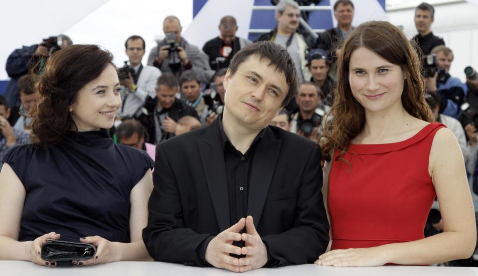 Director Director Christian Mungiu, center, poses with actors Cosmina Stratan, left, and Christina Flutur during a photo call for Beyond the Hills at the 65th international film festival, in Cannes, southern France, Saturday, May 19, 2012. (AP Photo/Francois Mori)