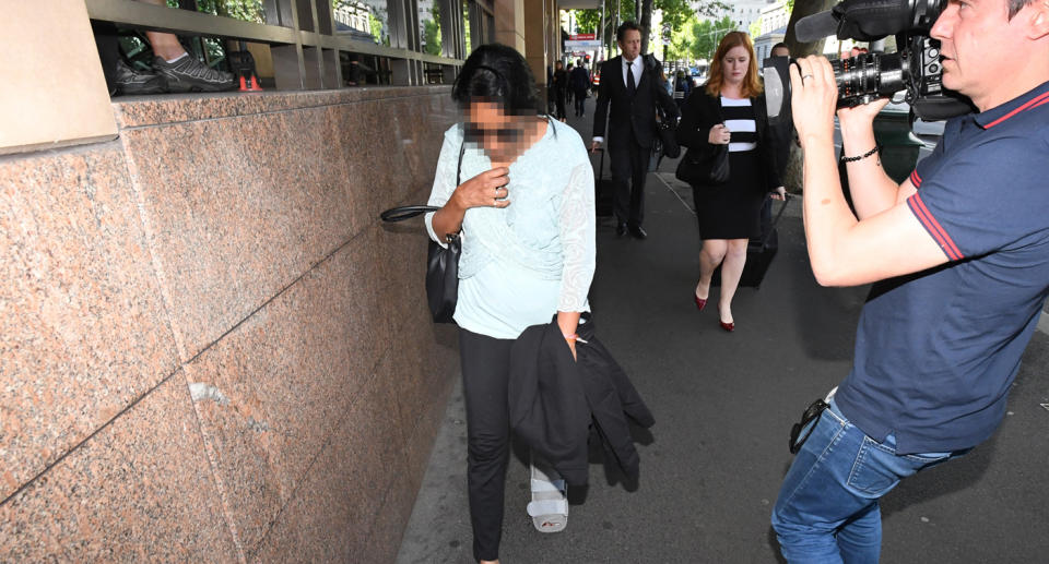 A woman leaves the Melbourne Magistrates Court in Melbourne.