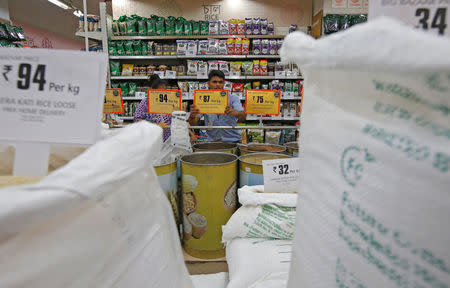 A worker arranges price tags of the food products at a store inside a shopping mall in Kolkata, June 20, 2018. Picture taken June 20, 2018. REUTERS/Rupak De Chowdhuri