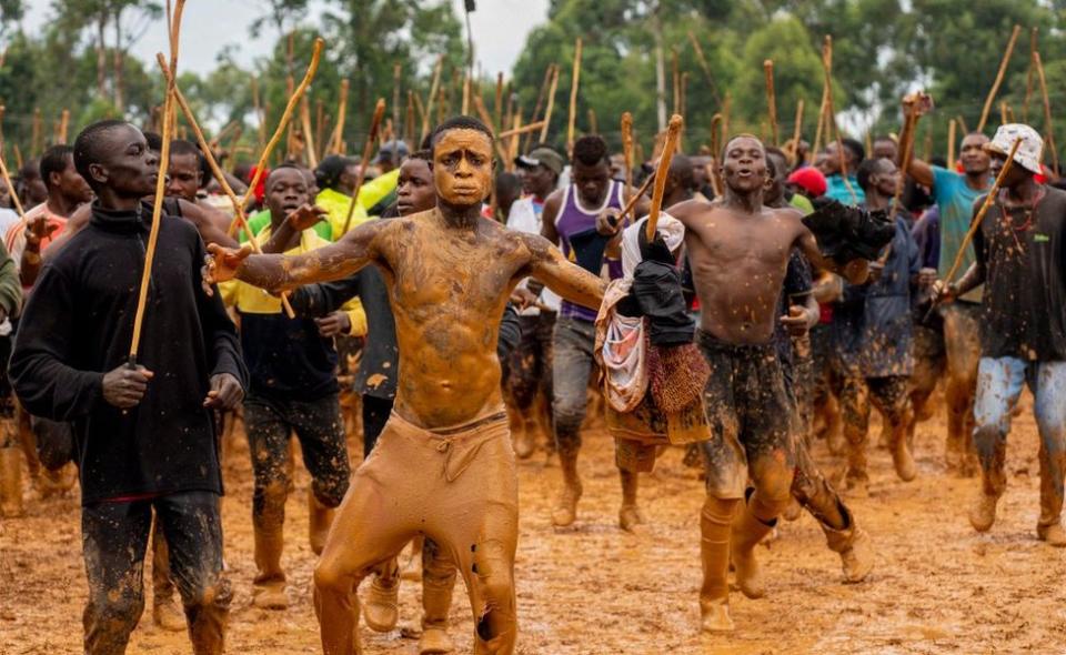 Supporters dance and chant in between matches during a traditional bullfighting tournament in Malinya Stadium, near Kakamega on January 1, 2024.