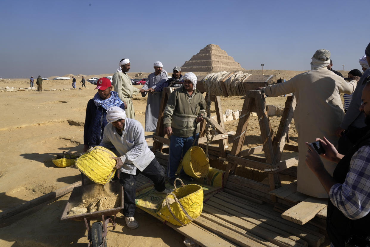 Egyptian antiquities workers dig at the site of the Step Pyramid of Djoser in Saqqara, 24 kilometers (15 miles) southwest of Cairo, Egypt, Thursday, Jan. 26, 2023. Egyptian archaeologist Zahi Hawass, the director of the Egyptian excavation team, announced that the expedition found a group of Old Kingdom tombs dating to the fifth and sixth dynasties of the Old Kingdom, indicating that the site comprised a large cemetery. (AP Photo/Amr Nabil)