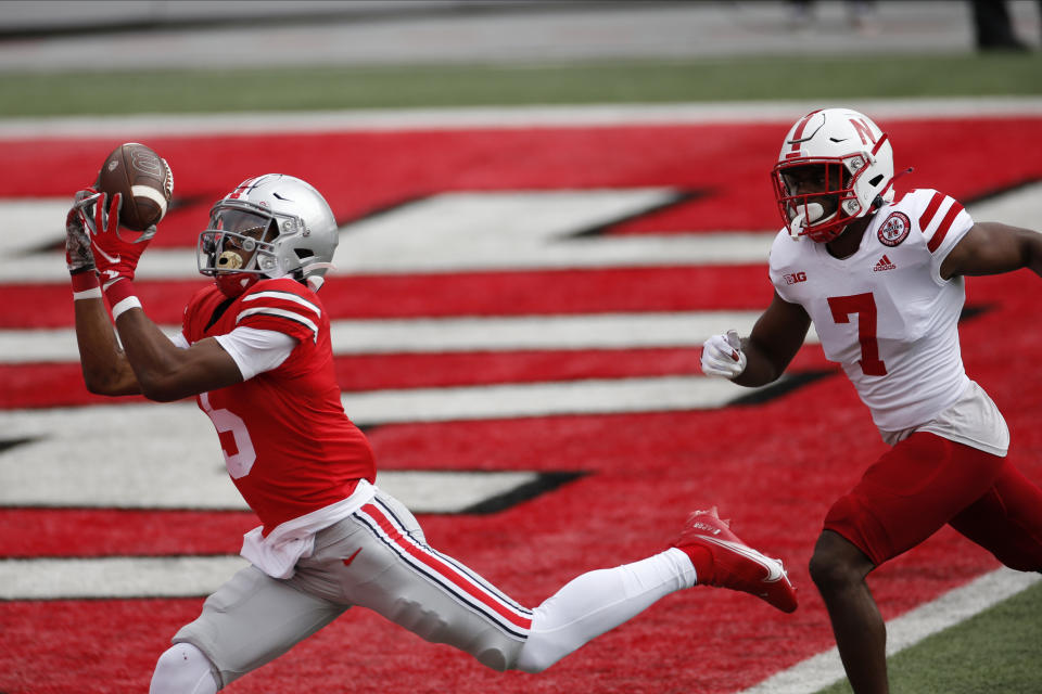 Ohio State receiver Garrett Wilson, left, catches a touchdown pass past Nebraska defensive back Dicaprio Bootle during the first half of an NCAA college football game Saturday, Oct. 24, 2020, in Columbus, Ohio. (AP Photo/Jay LaPrete)