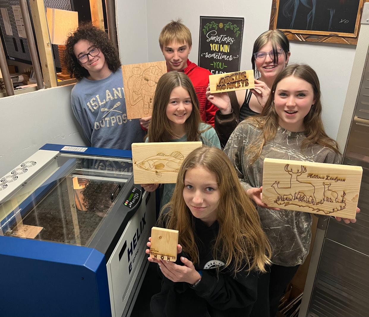 Eighth-grade students in Washington Island's technical education class show off the first laser engraving project they made in the school's existing fabrication laboratory, or "fab lab." The school district recently received a $25,000 grant from the Wisconsin Economic Development Corp. to expand its fab lab.