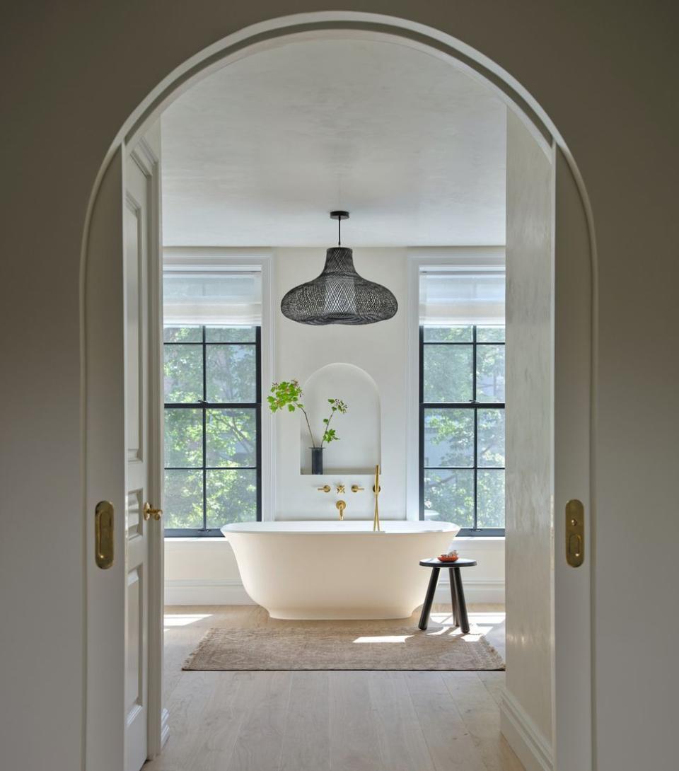 a bathroom with a tub and a chandelier