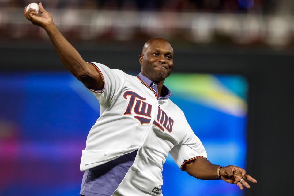 FILE - In this Monday, Oct. 7, 2019 file photo, former Minnesota Twins baseball player Torii Hunter throws out the ceremonial first pitch before Game 3 of the American League Division Series between the Twins and the New York Yankees, in Minneapolis. More than a dozen Black men, including Hunter, say the Red Sox have turned a deaf ear to claims they were sexually molested by former Red Sox clubhouse manager Donald “Fitzy” Fitzpatrick who pleaded guilty to attempted child sexual battery before his death in 2005. (AP Photo/Bruce Kluckhohn)