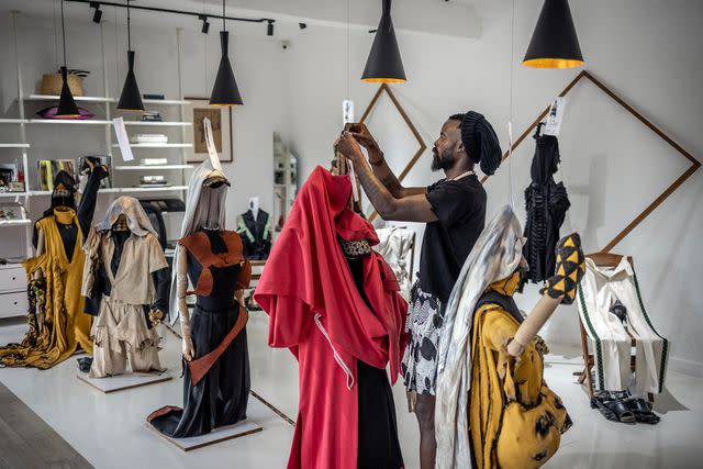 <p>Luis Tato/AFP/Getty Images</p> Designer Moïse Turahirwa styling pieces in their studio in Kigali