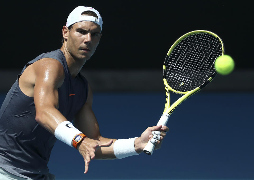 Spain's Rafael Nadal makes forehand return during a practice session ahead of the Australian Open tennis championship in Melbourne, Australia, Sunday, Jan. 19, 2020. (AP Photo/Dita Alangkara)