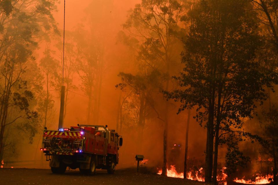 Fire trucks are seen during a bushfire in Werombi, 50km south west of Sydney, Friday, December 6, 2019. Source: AAP Image/Mick Tsikas.