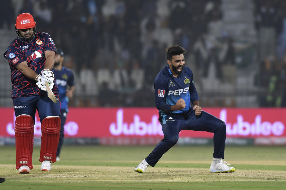 Multan Sultans' Usama Mir, right, celebrates after taking the wicket Islamabad United's Azam Khan, left, during the Pakistan Super League T20 cricket match between Multan Sultans and Islamabad United in Multan, Pakistan Tuesday, Feb. 20, 2024. (AP Photo/M. Khan)
