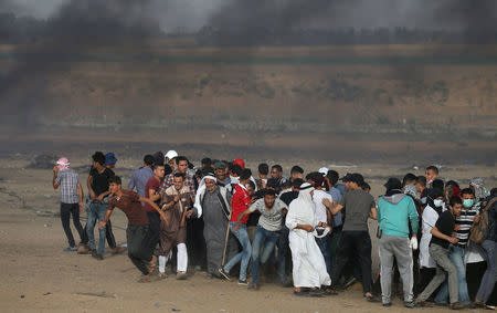 Palestinian demonstrators run for cover during a protest demanding the right to return to their homeland, at the Israel-Gaza border in the southern Gaza Strip May 25, 2018. REUTERS/Ibraheem Abu Mustafa