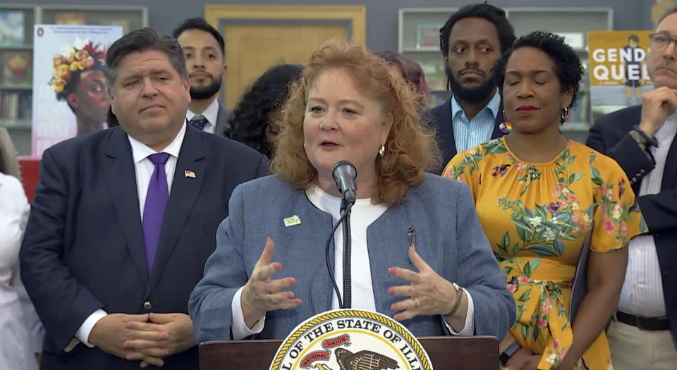 In this screenshot from a livestream broadcast by the State of Illinois, Sen. Laura Murphy, a Democrat from Des Plaines, speaks during a news conference and bill signing, Monday, June 12, 2023, at Harold Washington Library's Thomas Hughes Children's Library in downtown Chicago. The new law will require the state's libraries to uphold a pledge not to ban material because of partisan disapproval, starting on Jan. 1, 2024. If they refuse, they will not receive state funding. (State of Illinois via AP)
