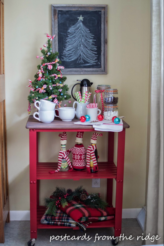 <p>Deck out your go-to place for a warm cup of your favorite festive beverage with cozy plaid throws and seasonal bottle cozies.</p><p>See more at <a href="http://www.postcardsfromtheridge.com/2014/12/home-for-holidays-2014-christmas-home.html" rel="nofollow noopener" target="_blank" data-ylk="slk:Postcards From the Ridge;elm:context_link;itc:0;sec:content-canvas" class="link ">Postcards From the Ridge</a>, </p>