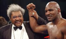 FILE PHOTO: Promoter Don King raises the hand of Evander Holyfield after his controversial win against Hasim Rahman in their non-title bout in Atlantic City, New Jersey.