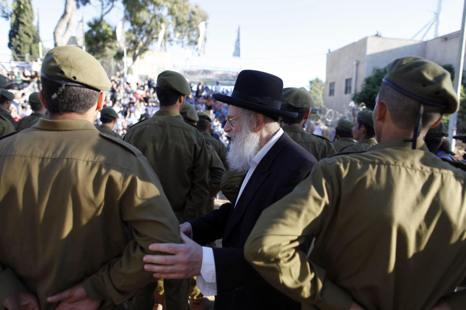 An ultra-Orthodox Jewish man greets volunteers during a military graduation ceremony on May 26, 2013 in Jerusalem, Israel, for members of the Netzah Yehuda battalion, which was formed in 1999 to allow ultra-Othodox Israelis to enlist. / Credit: Lior Mizrahi/Getty