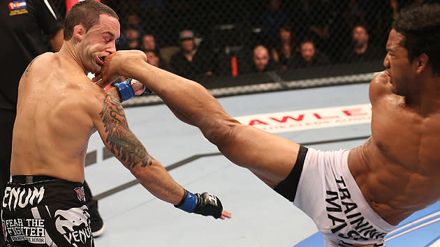 Benson Henderson kicks Frankie Edgar in the face during their UFC 150 fight.