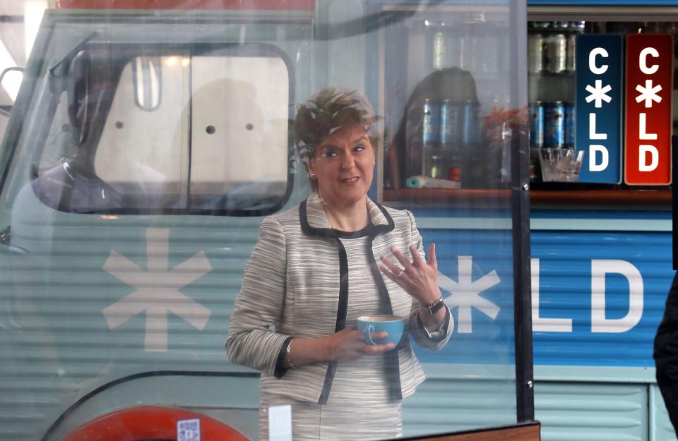 Scotland's First Minister, Nicola Sturgeon beside a screen which has been erected around tables during a visit to Cold Town House in Edinburgh's Grassmarket in Edinburgh on July 3, 2020, where she saw the changes in place to keep staff and customers safe in the outdoor hospitality industry as Scotland prepares for a further loosening of the COVID-19 lockdown. (Photo by Andrew Milligan / POOL / AFP) (Photo by ANDREW MILLIGAN/POOL/AFP via Getty Images)