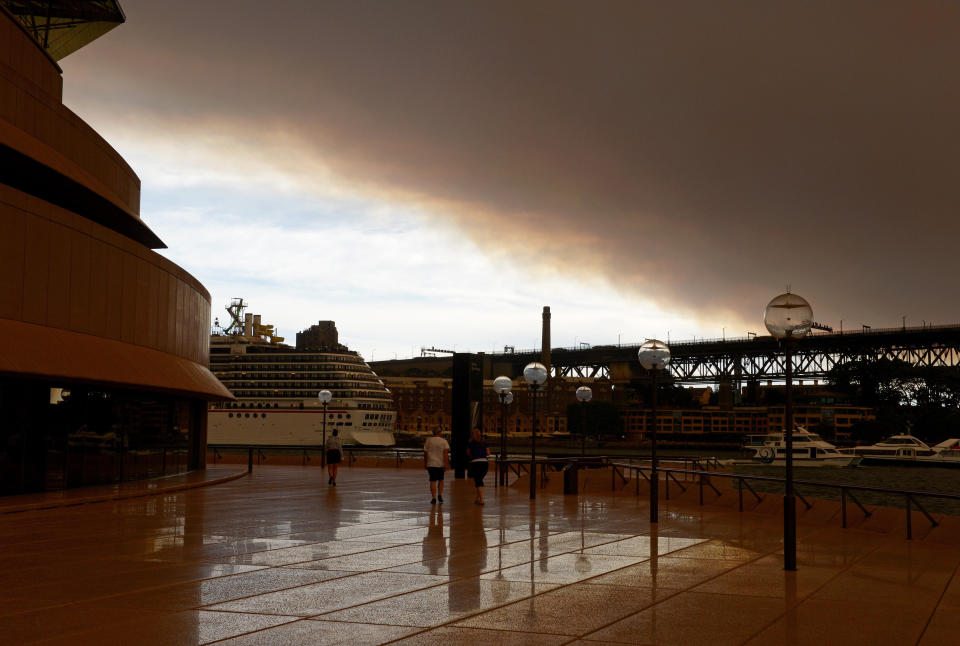 Smoke and ash from wildfires burning across the state of New South Wales blankets Sydney Harbour in this photo taken from the Sydney Opera House on October 17, 2013. (GREG WOOD/AFP/Getty Images)