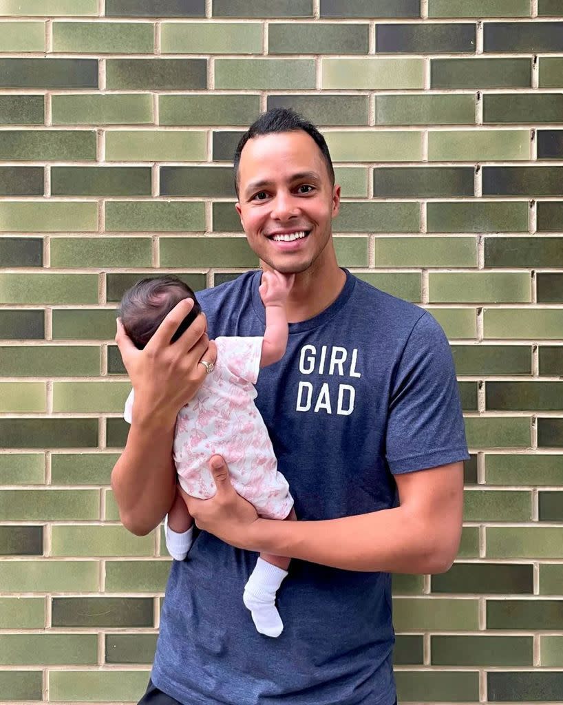 will kirk from the repair shop wearing girl dad tshirt holding baby