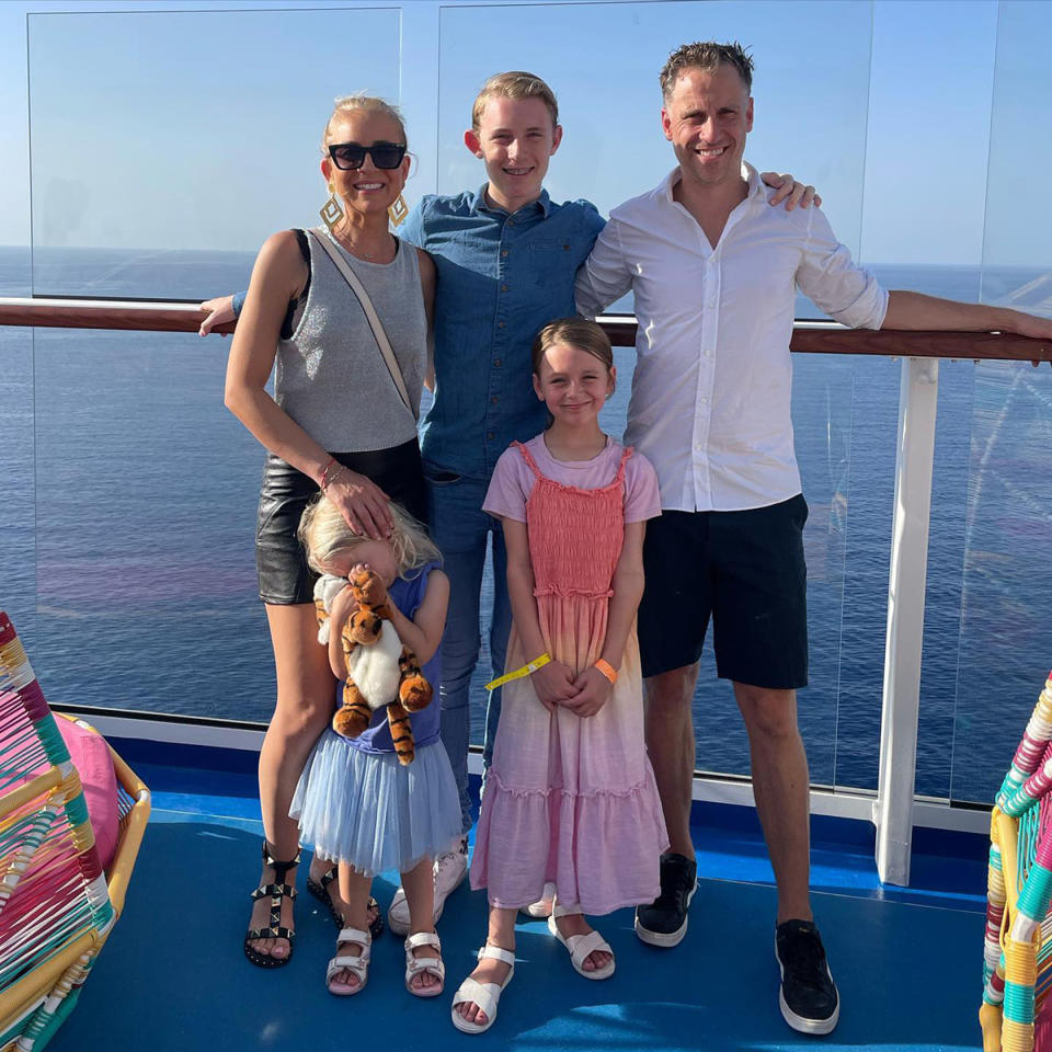 Carrie Bickmore poses with her family on a cruise ship balcony