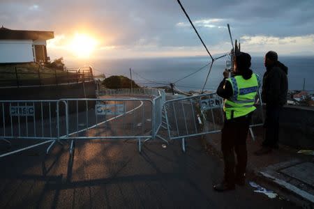 A police officer takes pictures at the site of a bus accident, in Canico, in the Portuguese Island of Madeira, April 18, 2019. REUTERS/Duarte Sa