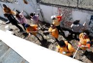 Students from Eastside High School paint over graffiti on the walls of Hinchliffe Stadium, Wednesday, April 16, 2014, in Paterson, N.J. Hinchliffe Stadium in Paterson was once home to the New York Black Yankees, the New York Cubans and other Negro League baseball teams. Eleven members of the National Baseball Hall of Fame played there, including Larry Doby. The crumbling Art Deco stadium was granted national historic landmark status in 2013. Lawmakers are pushing to designate it as part of the nearby Great Falls National Historical Park. (AP Photo/Julio Cortez)