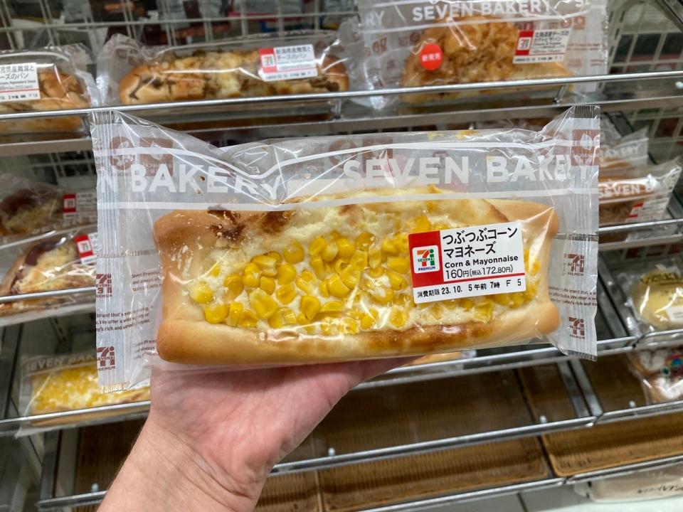 A pastry inside packaging in a hand  inside a 7-Eleven in Japan 